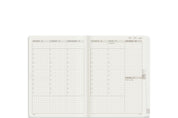 Wonderland 222 2026 A6 Weekly stacked planner spread with vertical daily columns, hourly schedule 7 to 21, top priorities section, mini calendar, and minimalist grid layout on white fountain pen friendly paper