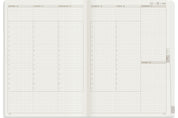Wonderland 222 2026 A5 Weekly stacked planner spread with vertical daily columns, hourly schedule 7 to 21, top priorities section, mini calendar, and minimalist grid layout on white fountain pen friendly paper
