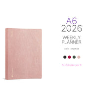 Wonderland 222 2026 A6 Weekly Planner Core Stacked in Alpine Glow, textured blush pink hardcover with gold foil 2026 detail, minimalist planner