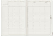 Wonderland 222 2026 A5 Weekly Unstacked planner spread with vertical daily columns, hourly schedule 7 to 21, top priorities section, mini calendar, and minimalist grid layout on white fountain pen friendly paper