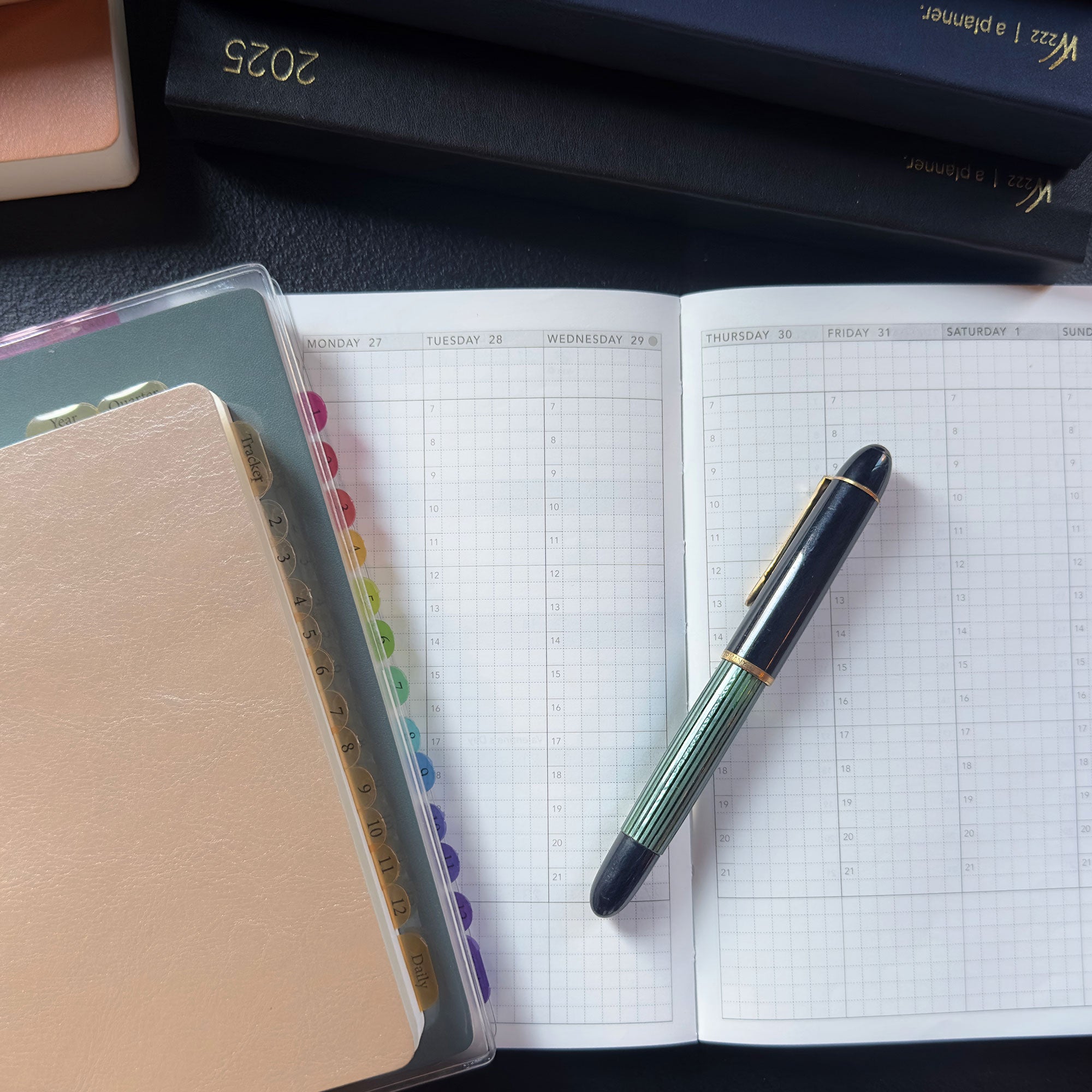 An open Wonderland 222 weekly vertical planner.  Tomoe River paper by Tomoegawa.  Vintage Pelikan fountain pen.  Monthly Clear transparent index tabs 